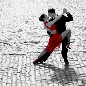 Couple dancing Tango on cobblestone road