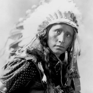 Indian wearing White War Bonnet- 1900